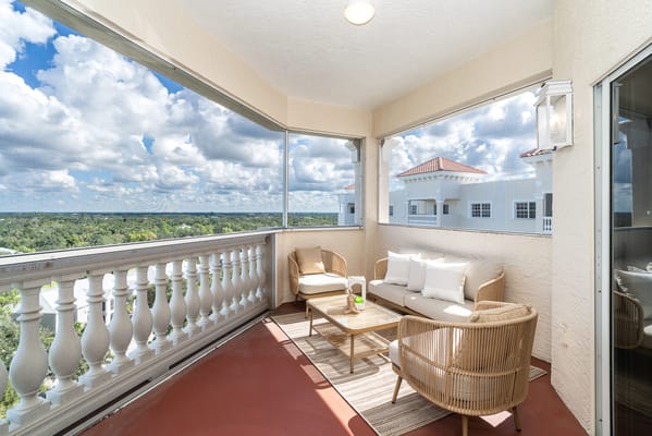 Balcony seating area with a view of the sky and landscape