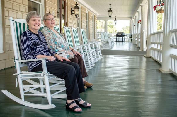 Two residents enjoying a relaxing moment on the porch