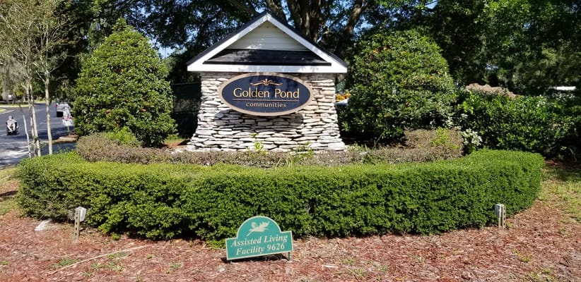 Exterior sign of Golden Pond Communities with landscaped garden