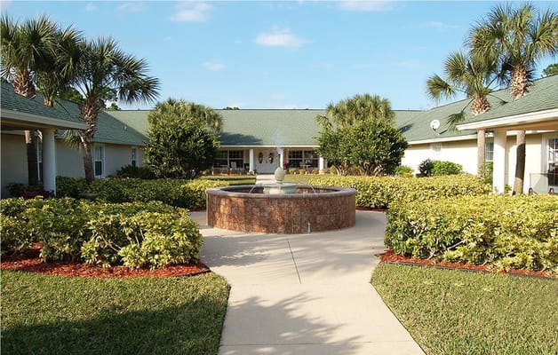 Outdoor courtyard with fountain surrounded by greenery