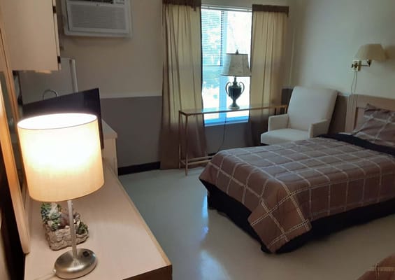 A private resident room with bed and furnishings