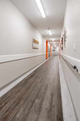 Interior hallway with bright lighting and wood flooring