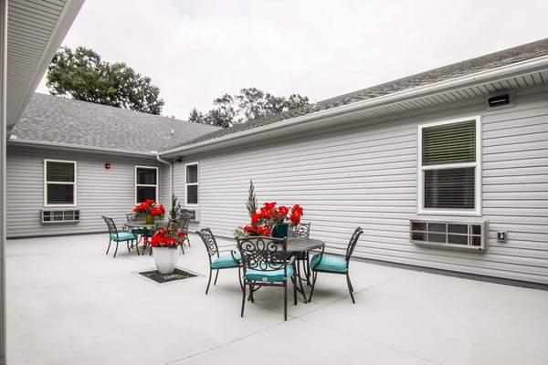 Outdoor seating area with flowers and tables