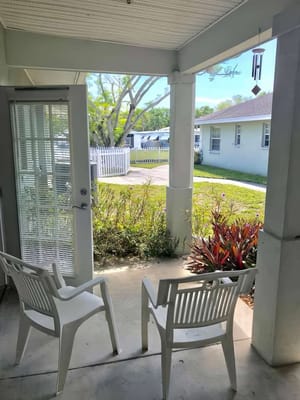 View of outdoor seating area with garden