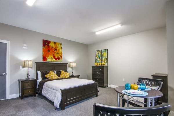 A well-furnished resident room with cozy decor