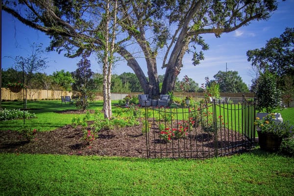 A serene garden area with seating and flowers