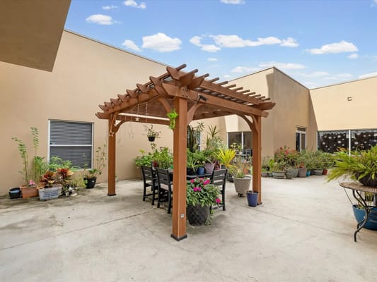 Outdoor seating area with pergola and flowers