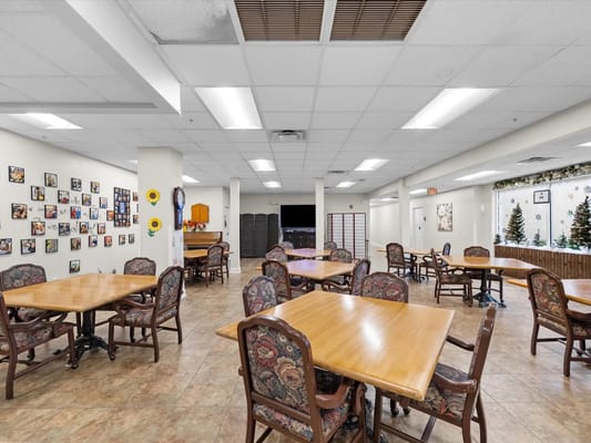 Common area with tables and chairs for activities