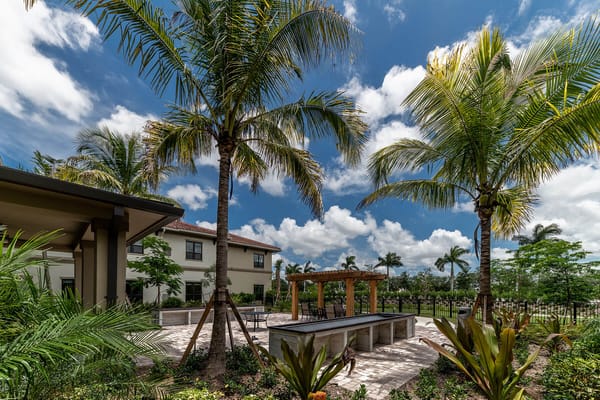 Outdoor seating area with palm trees and a patio