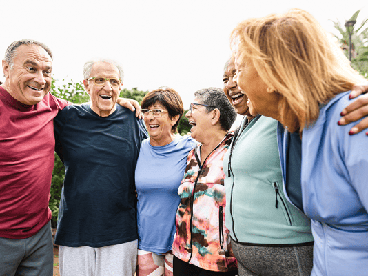 Residents and staff enjoying a cheerful moment outdoors