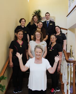 Staff members posing on the stairs in the facility