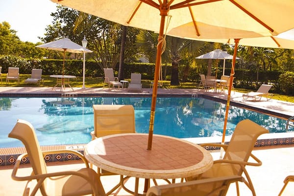 Swimming pool area with lounge chairs and umbrellas
