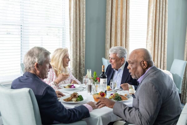Residents enjoying a meal together in the dining room