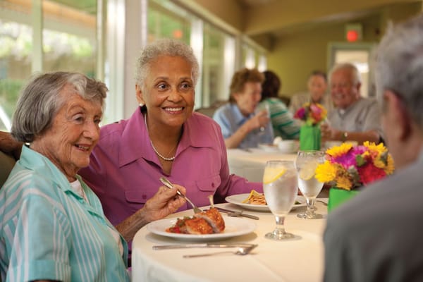 Residents enjoying a meal in a dining room