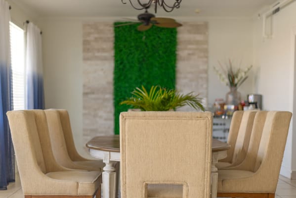 Dining area with a large wooden table and beige chairs