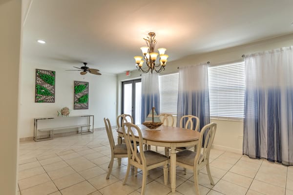 Bright common area with a dining table and seating