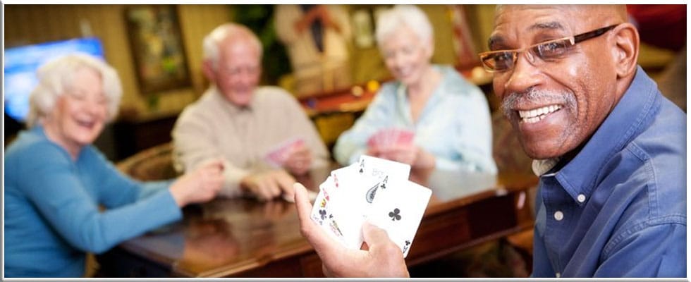 Residents enjoying a game of cards in a common area