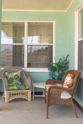 Outdoor seating area with wicker chairs and plants