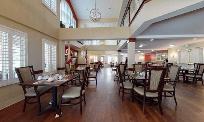 Dining area with tables and chairs set for meals