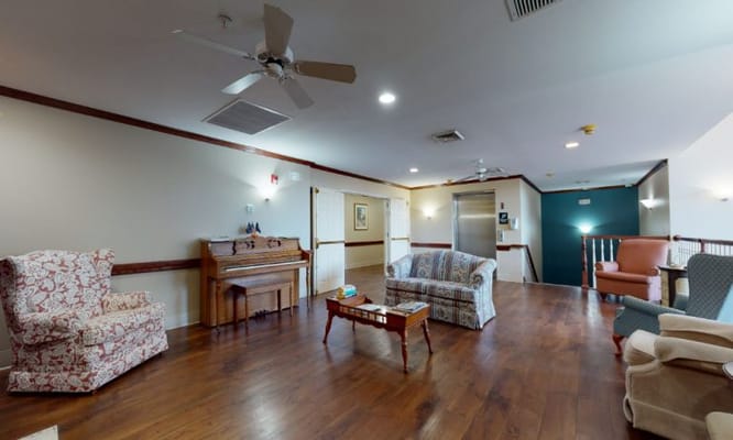 Common area with seating and a piano in the facility