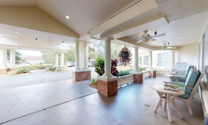Covered patio area with seating and plants
