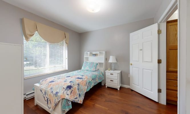 Cozy private resident room with a single bed and natural light