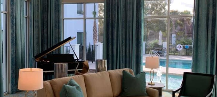 Lounge area with a view of the pool and grand piano