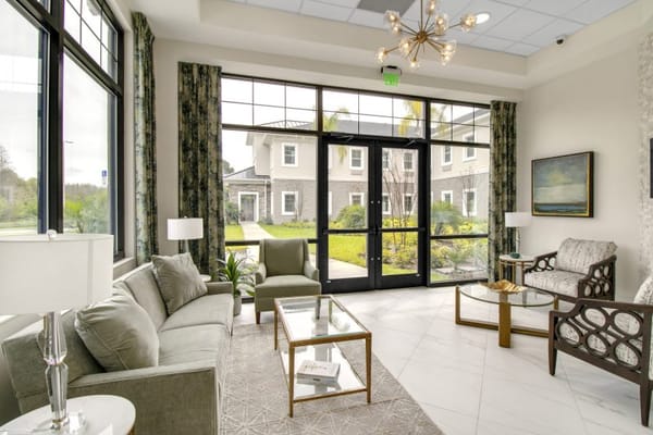 Bright common area with seating and garden view