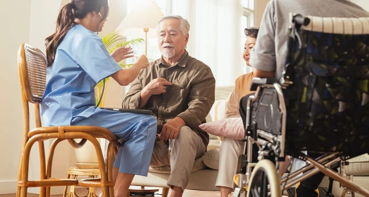 A caregiver interacts with residents in a common area