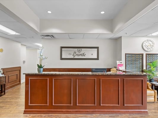 Reception area with wooden counter and signage