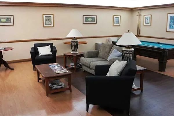 Interior view of a cozy common area with seating and pool table