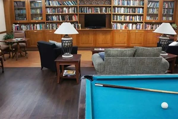 Interior common area with seating and bookshelves