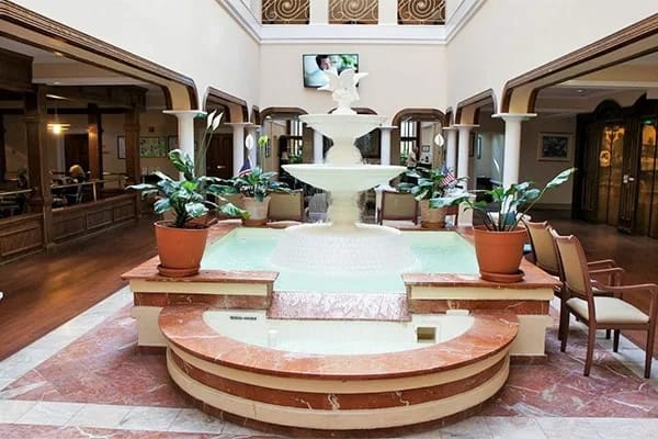 Indoor common area featuring a fountain and seating