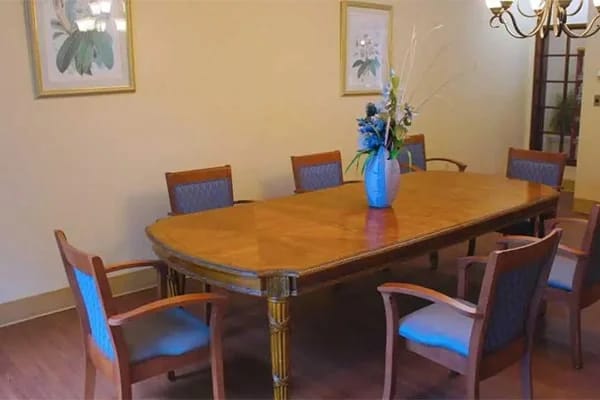 Dining room with a large table and floral centerpiece