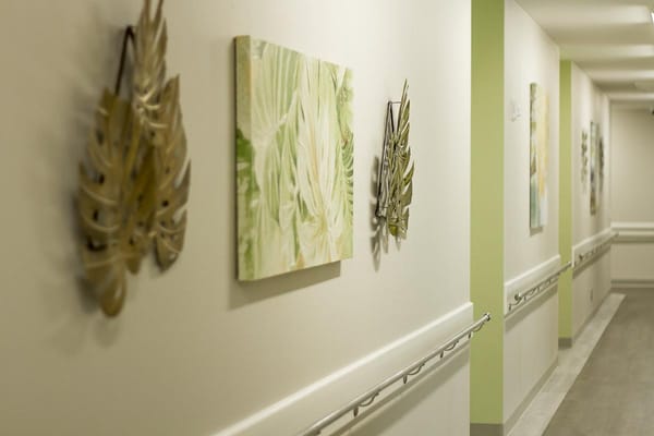 Decorative hallway with wall art in a senior care facility