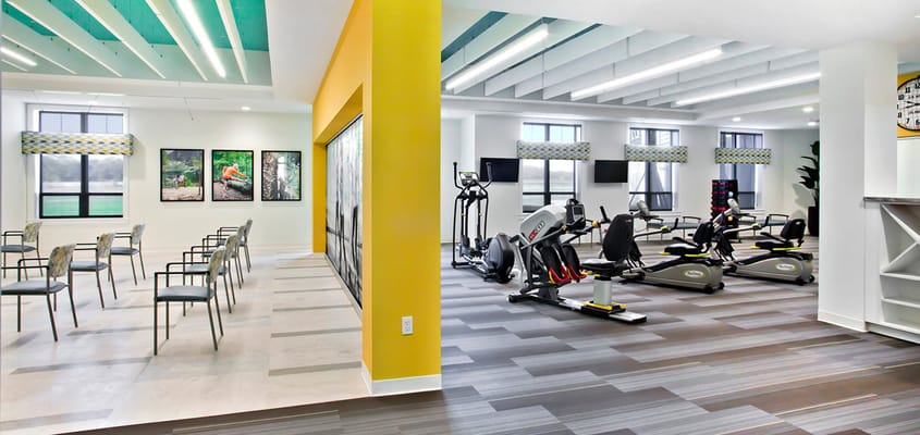 Interior exercise and common area with equipment