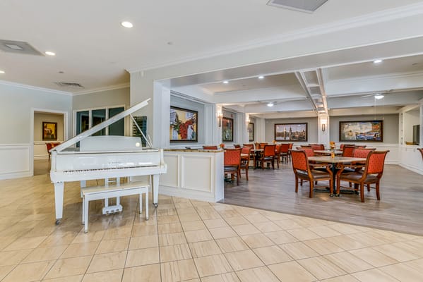 Bright dining area with a grand piano
