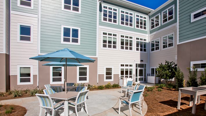 Outdoor seating area with umbrellas and landscaping