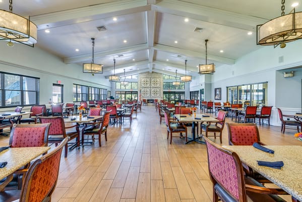 Dining room with tables and chairs set for residents