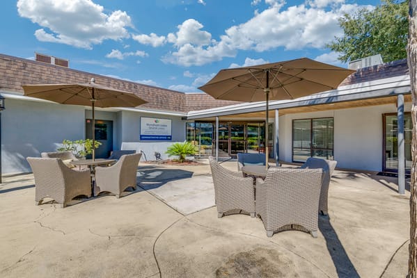 Outdoor seating area with umbrellas at Wyndham Lakes