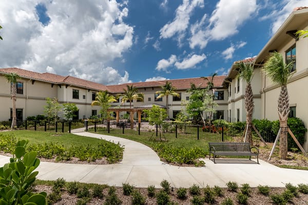 Exterior view of a senior living facility with landscaped gardens