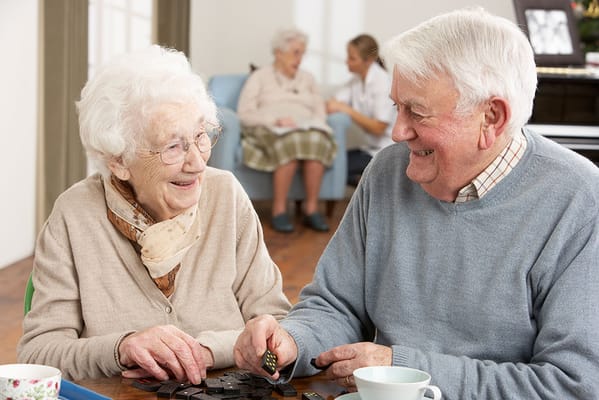 Residents enjoying a board game together