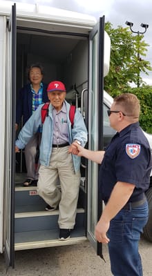 Residents boarding a facility transport vehicle.
