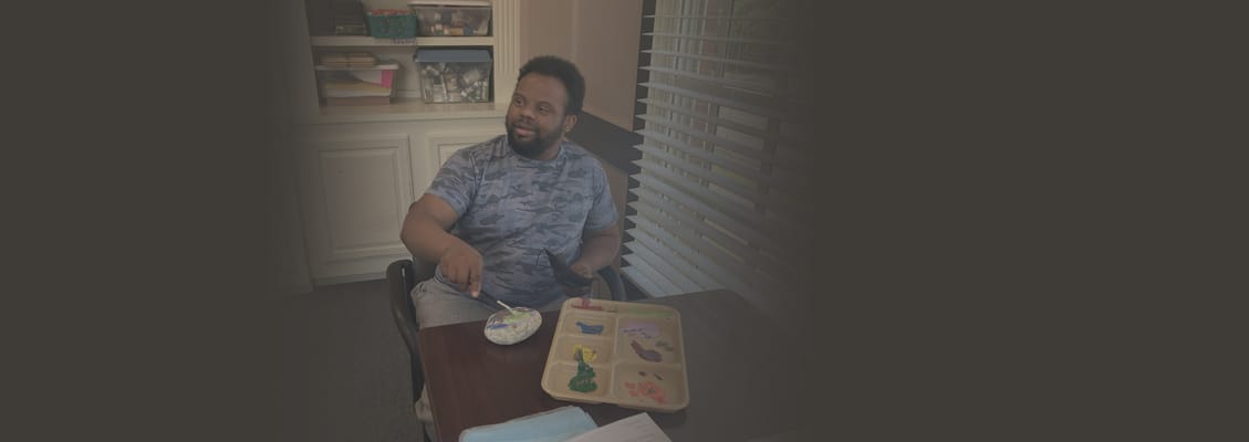 Resident engaging in a painting activity at a table