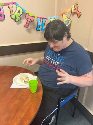 Resident enjoying food during a birthday celebration