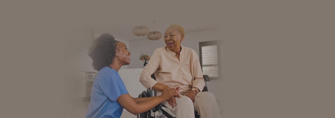Caregiver interacting warmly with an elderly resident
