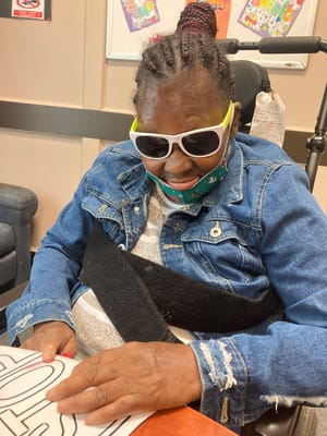 Resident participating in an indoor activity with art supplies