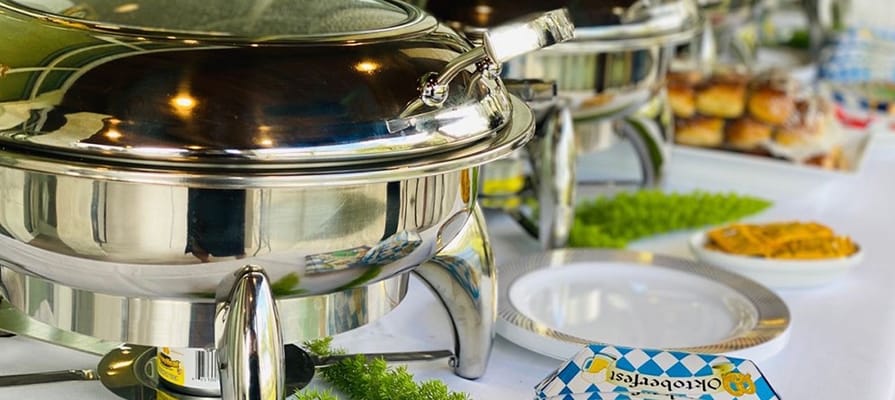 Buffet setup with food trays and plates