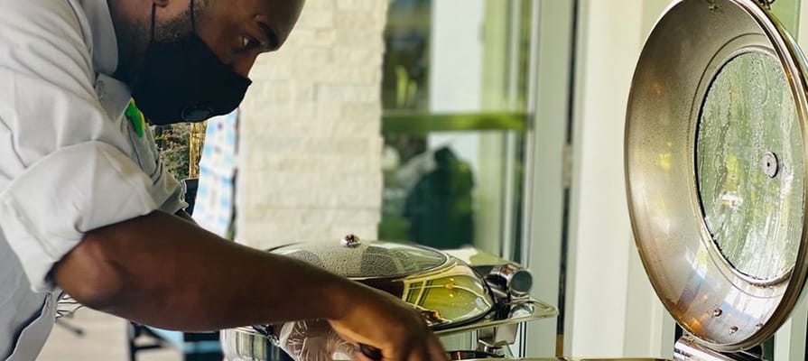 Staff member serving food at a dining area