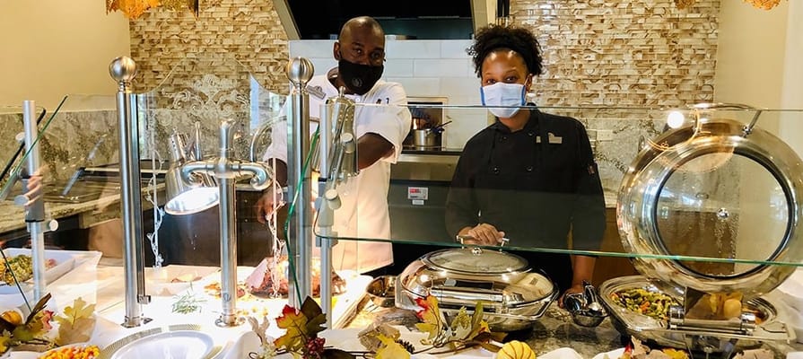Friendly staff serving food in the dining area